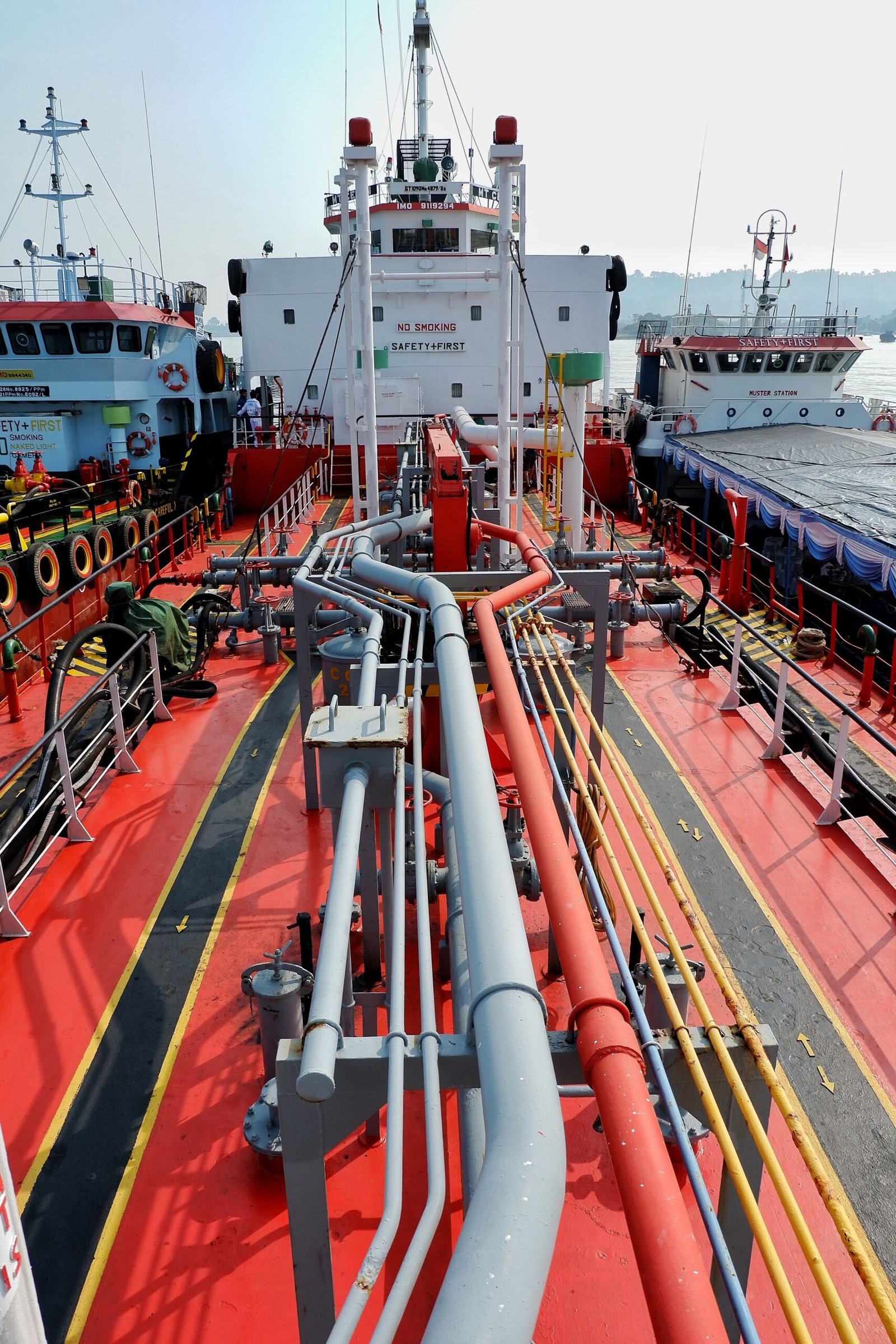 What We Do A detailed view of a shipping tanker's deck and pipeline system docked in Banten, Indonesia.