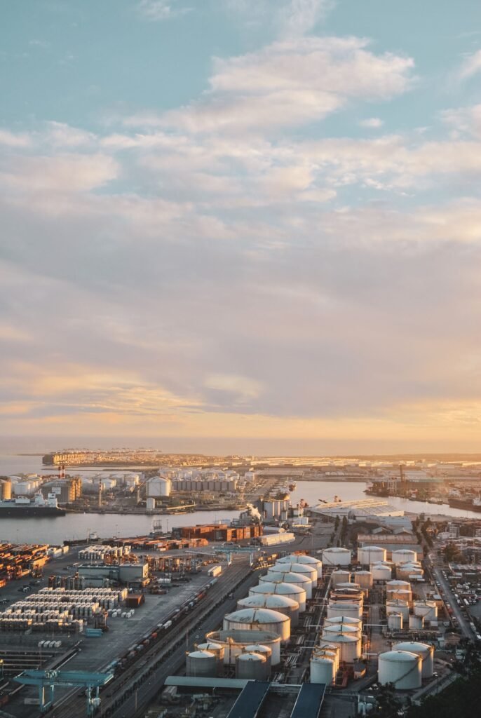 Trading Aerial photo capturing Barcelona's industrial port during a stunning sunset, highlighting the city's industrial landscape.