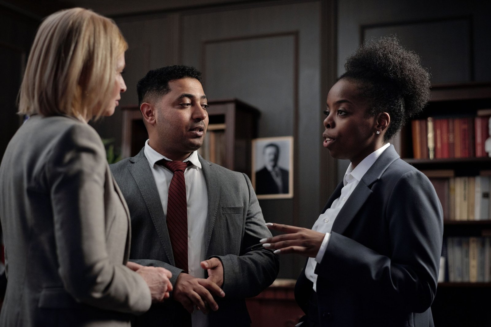 Home Diverse professionals engaged in strategic discussion in a law office setting.